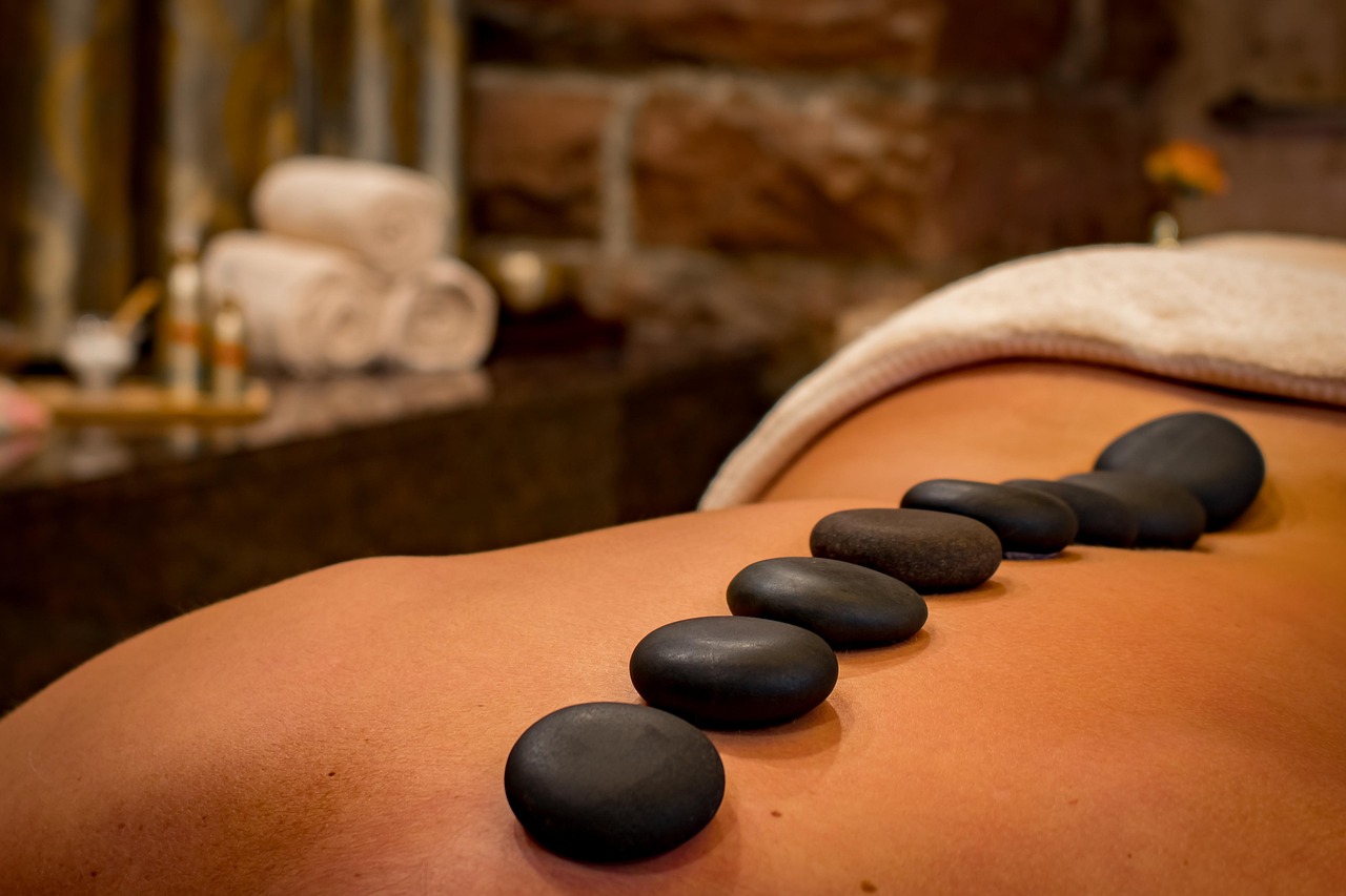 Peaceful massage room with soft lighting and soothing decor, inviting clients to schedule their appointment.