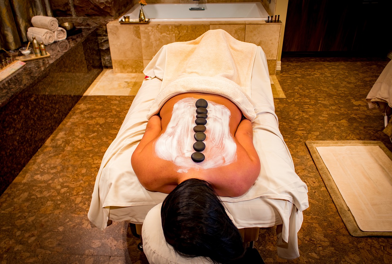 Relaxing massage spa environment with calming decor and massage tables.